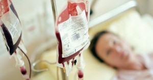 0_Woman-lying-in-hospital-bed-focus-on-IV-drips-filled-with-blood-580x305